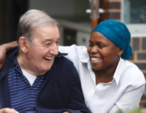 Young woman with elderly man laughing