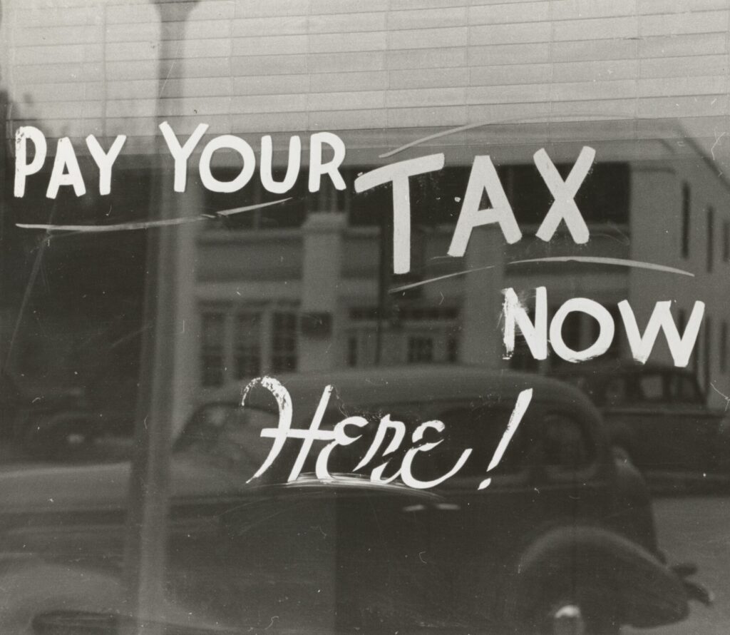 a sign that says pay your tax now here